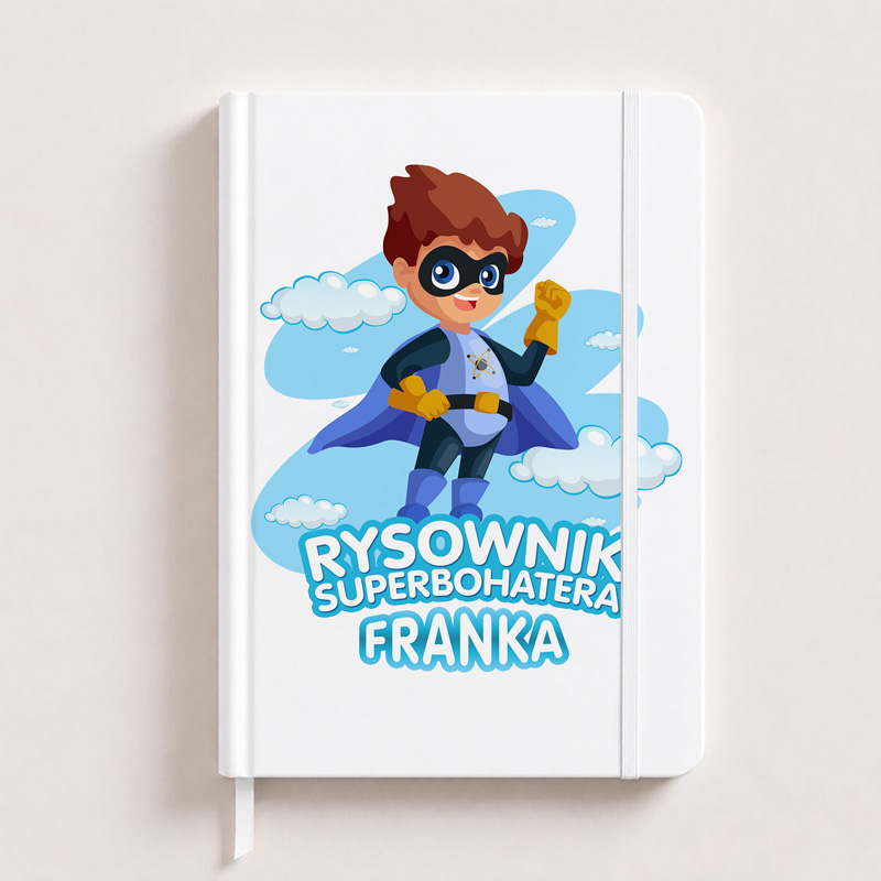 Notatnik z ilustracją chłopca w stroju superbohatera, w kapeluszu i masce, z napisem "RYSWOWNIK SUPERBOHATERA FRANKA" na okładce.