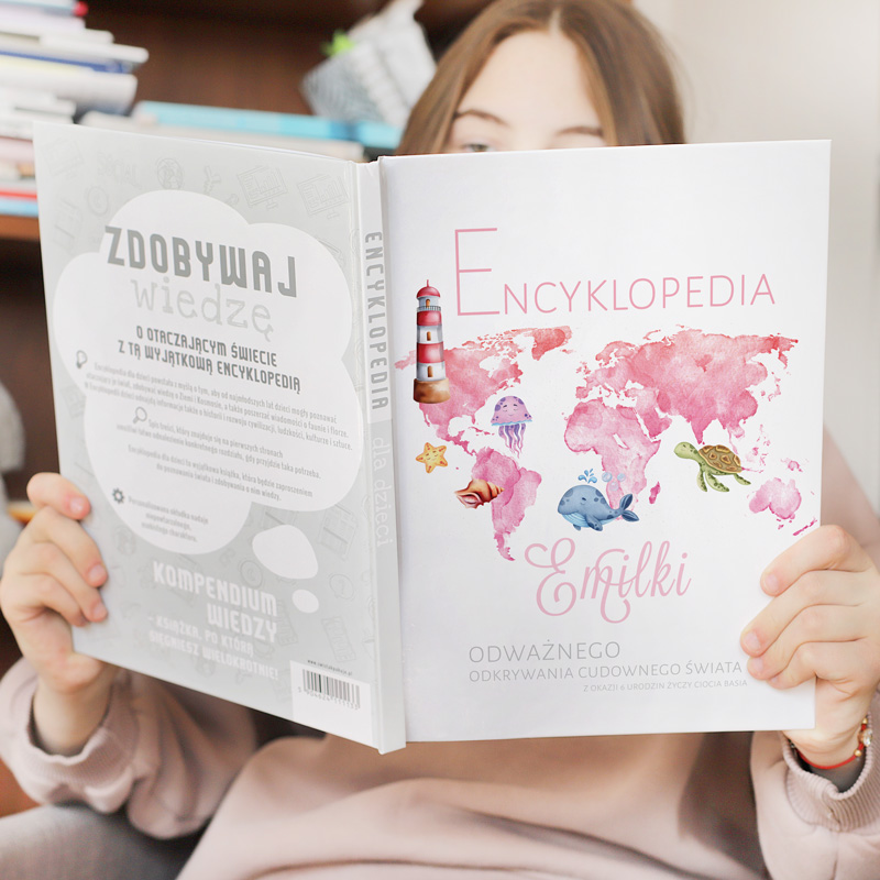 Pierwsza encyklopedia dla dziecka. Książka z imieniem na okładce. Grafika mapy świata, różowa kolorystyka.