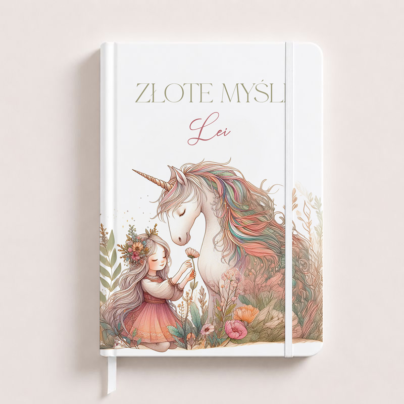 Notatnik z ilustracją dziewczynki w różowej sukience, która dotyka białego jednorożca z tęczową grzywą, otoczonych kwiatami. Na okładce napis "Złote Myśli".