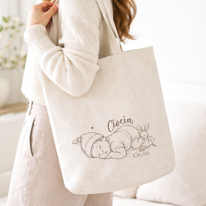 Torba na ramię z rysunkiem śpiącego dziecka w czapce oraz króliczkiem, z napisem "Ciocia".